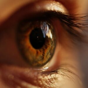 A striking macro close-up of a human eye showcasing the intricate details of the iris and eyelashes.